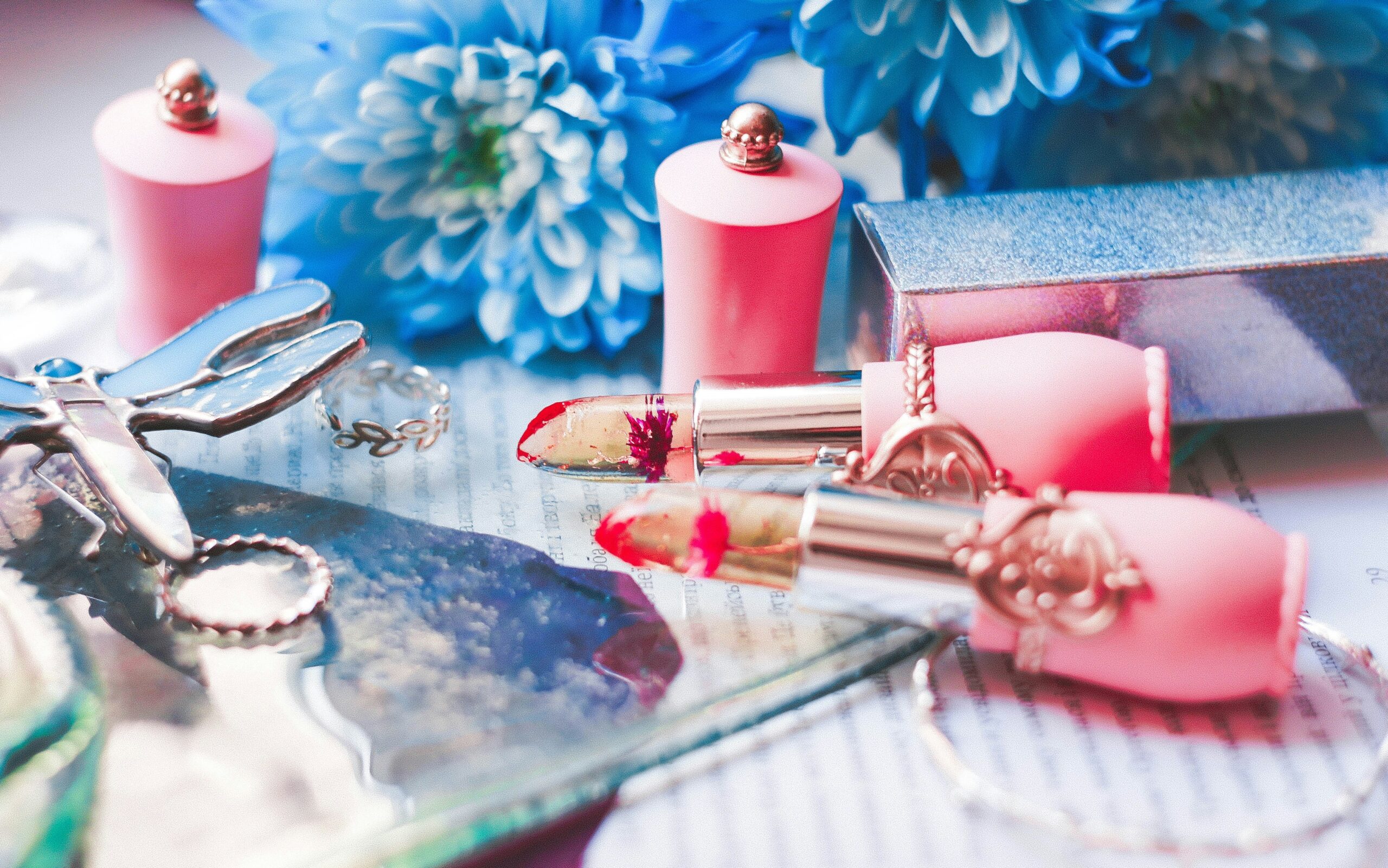 A collection of colorful makeup palettes laid out on a vanity table.