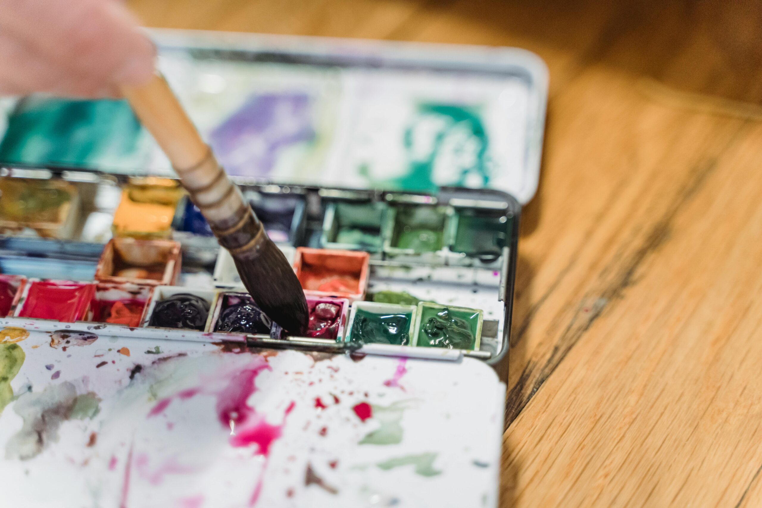 Close-up image showing professional artist using fluffy blending brush
