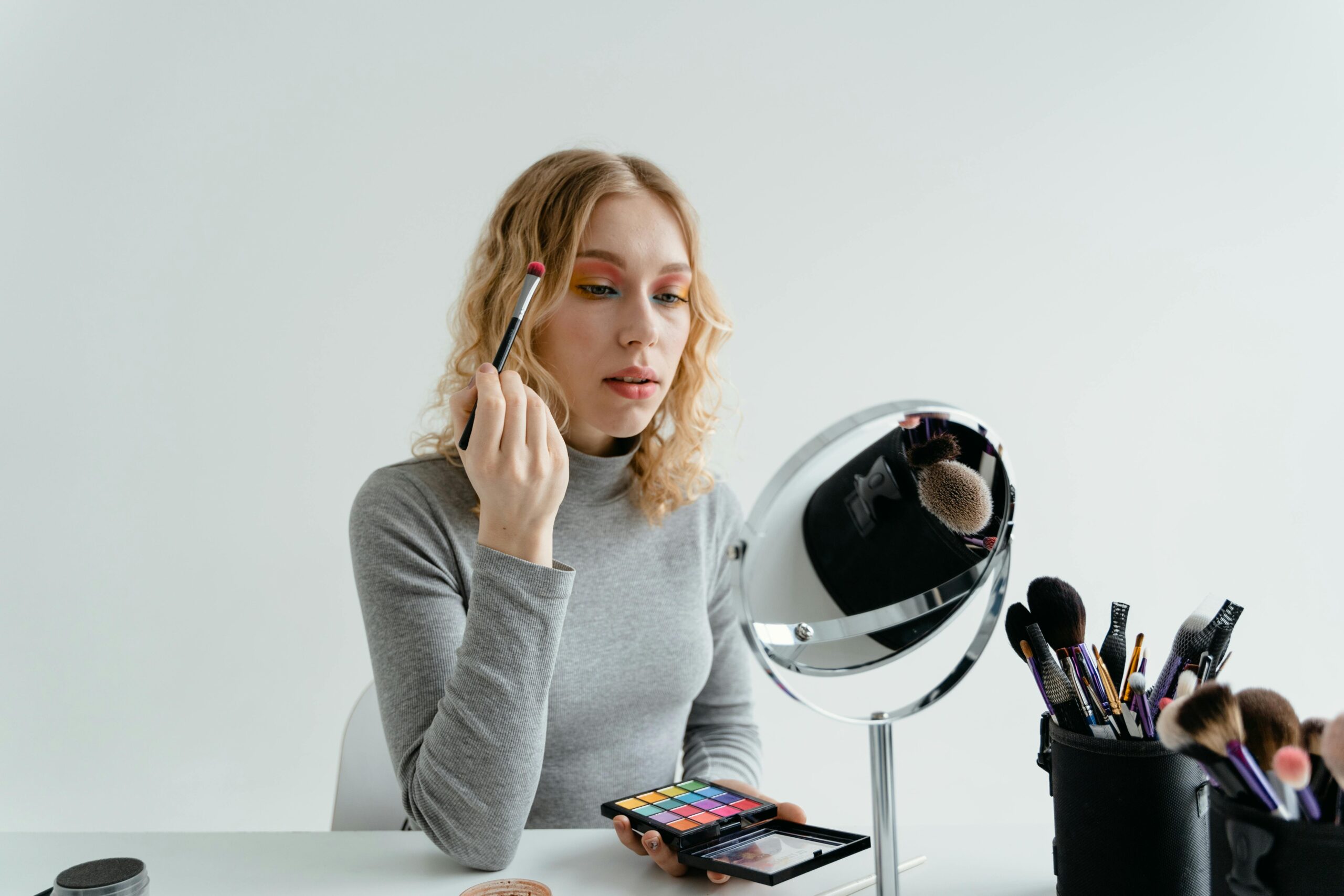 Sarah applying makeup using her favorite compact All-in-One palette