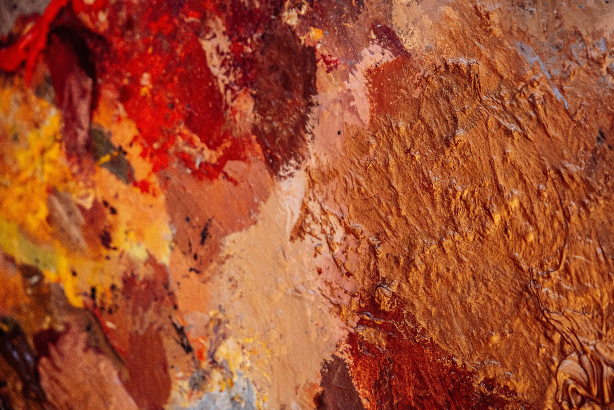 A colorful eyeshadow palette featuring vibrant shades like red, purple, and teal.