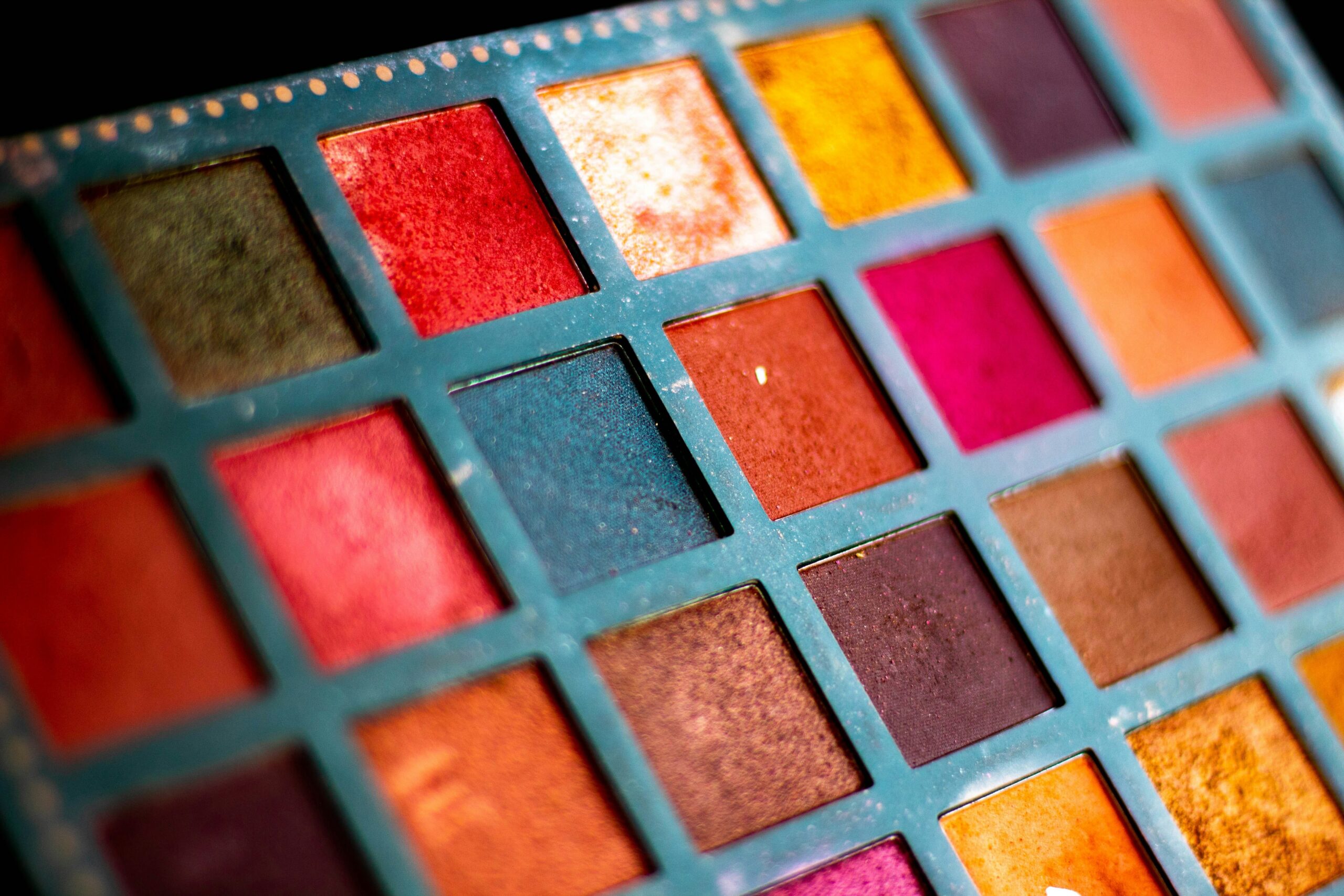 A sleek metallic travel makeup palette with multiple shades and mirror