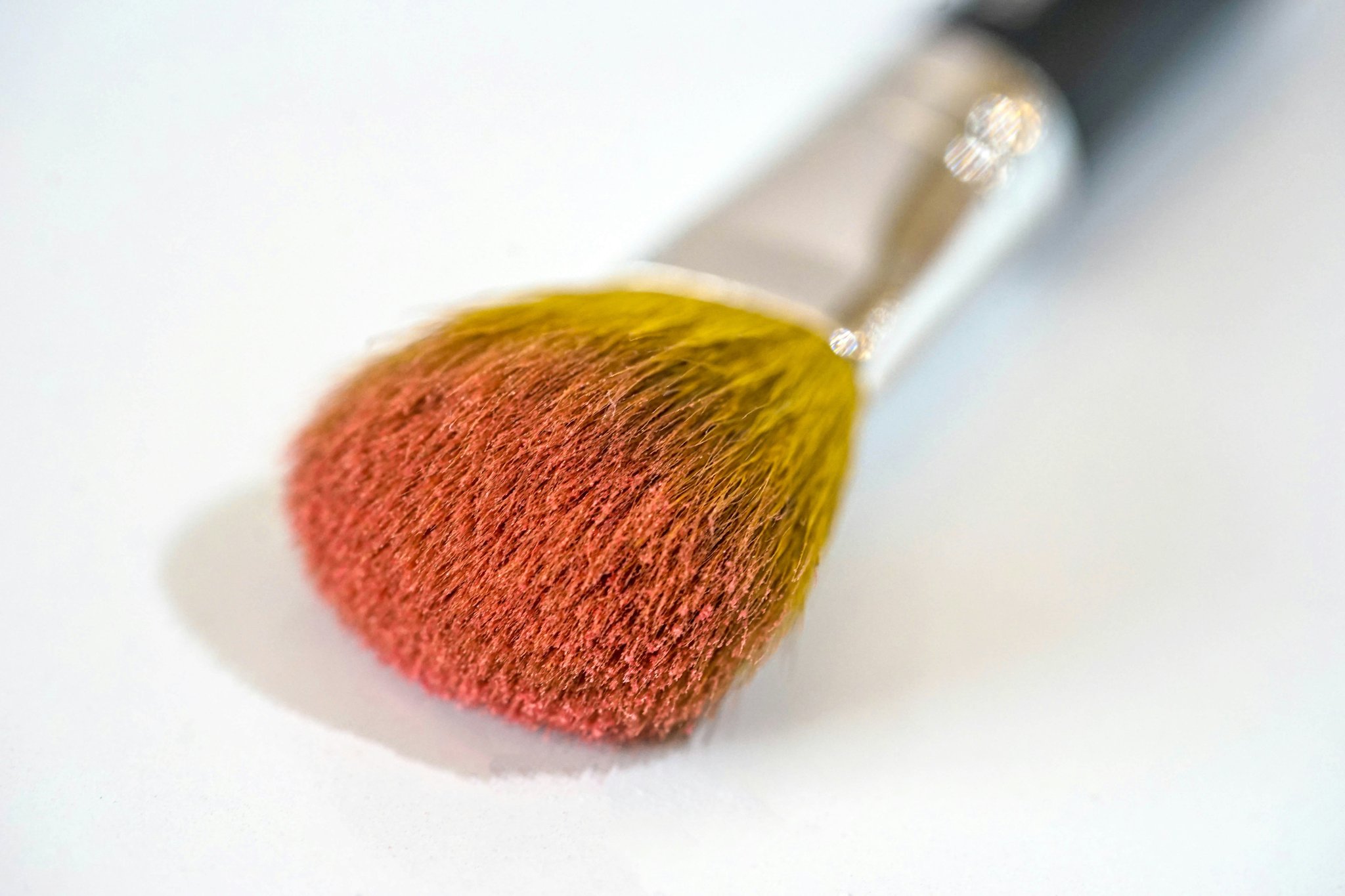 A close-up shot of a high-quality bold color eyeshadow palette with vibrant shades.
