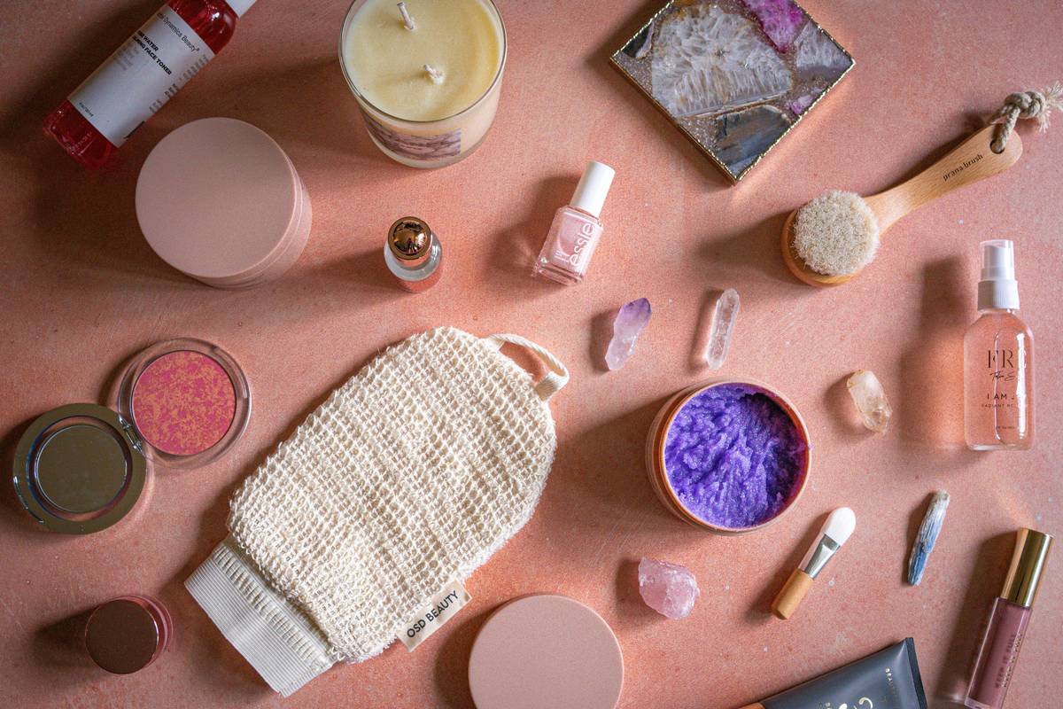 A woman holding a non-comedogenic eyeshadow palette on her vanity.