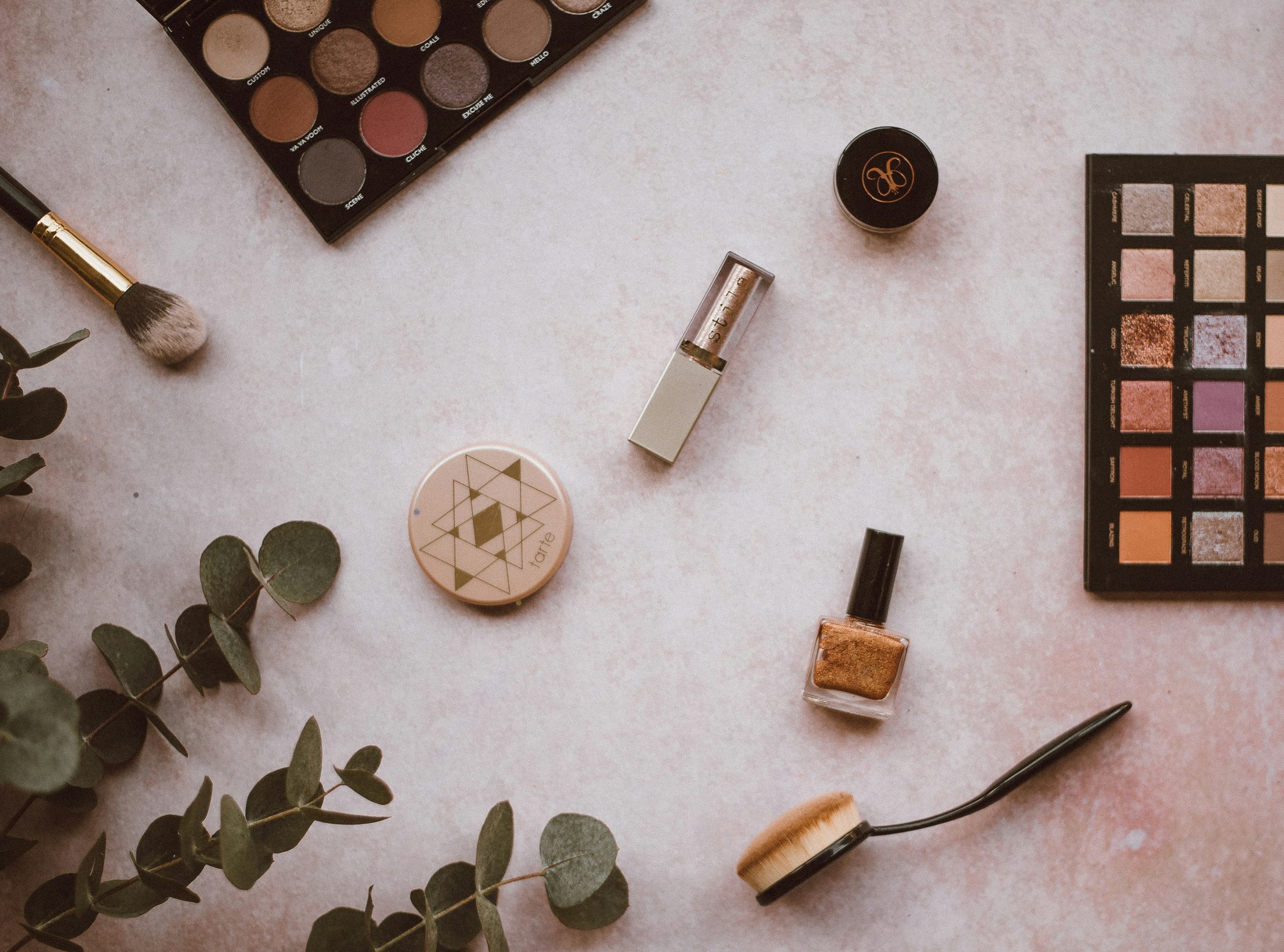 Scattered makeup products on a vanity table representing chaos