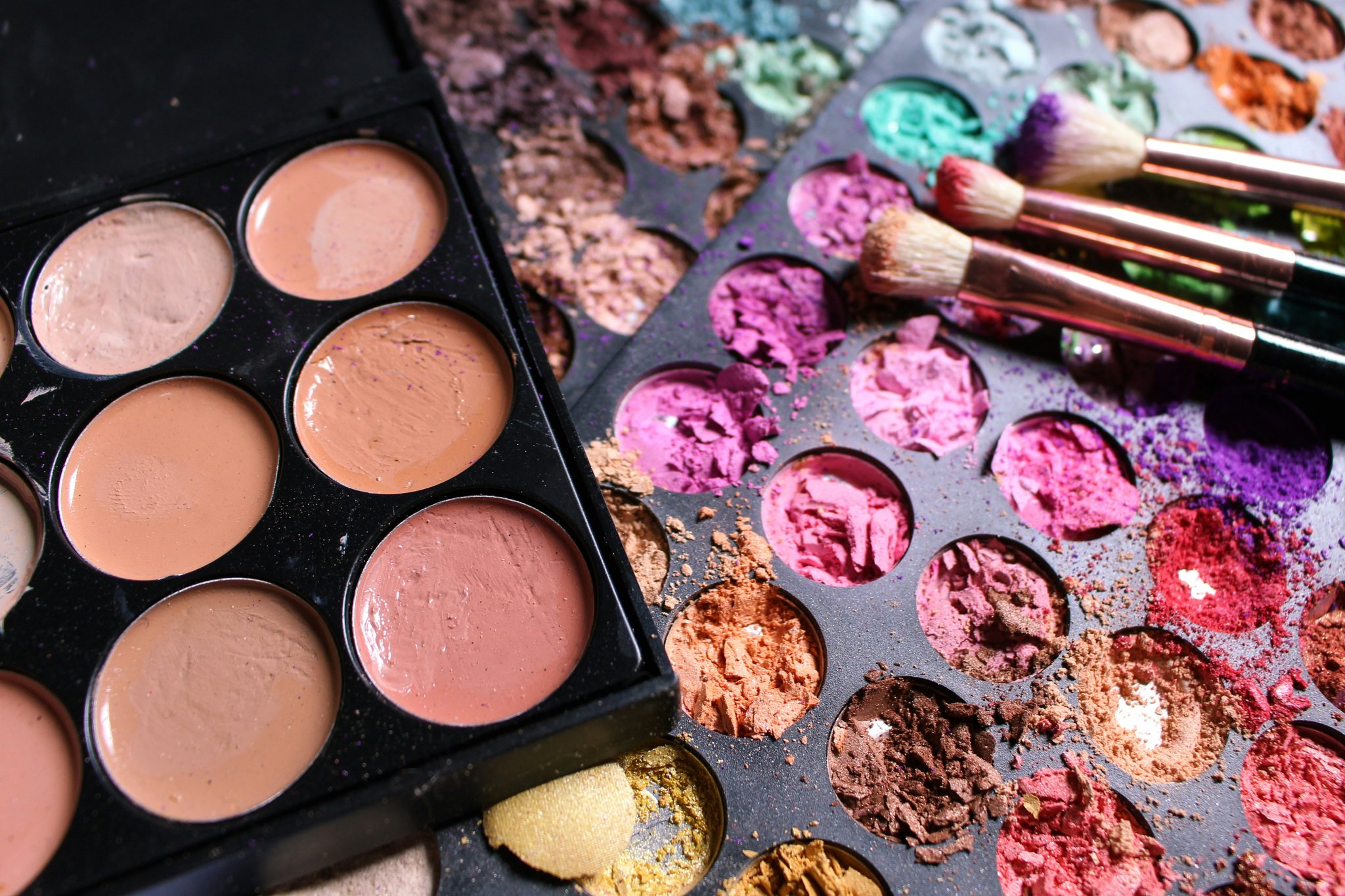 Smiling woman applying makeup using a multi-use palette