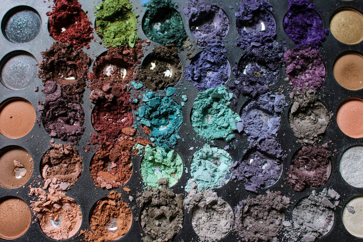Various face sculpting palettes lined up on a vanity