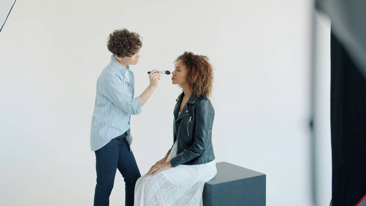 Makeup artist using soft brush to blend eyeshadow seamlessly